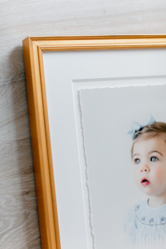 Gold deckled framed print of little girl.