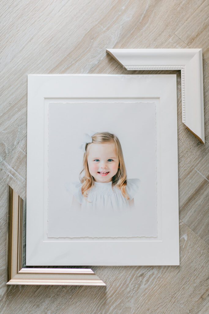 Children's heirloom portrait matted print with sample frame corners around the matted print.