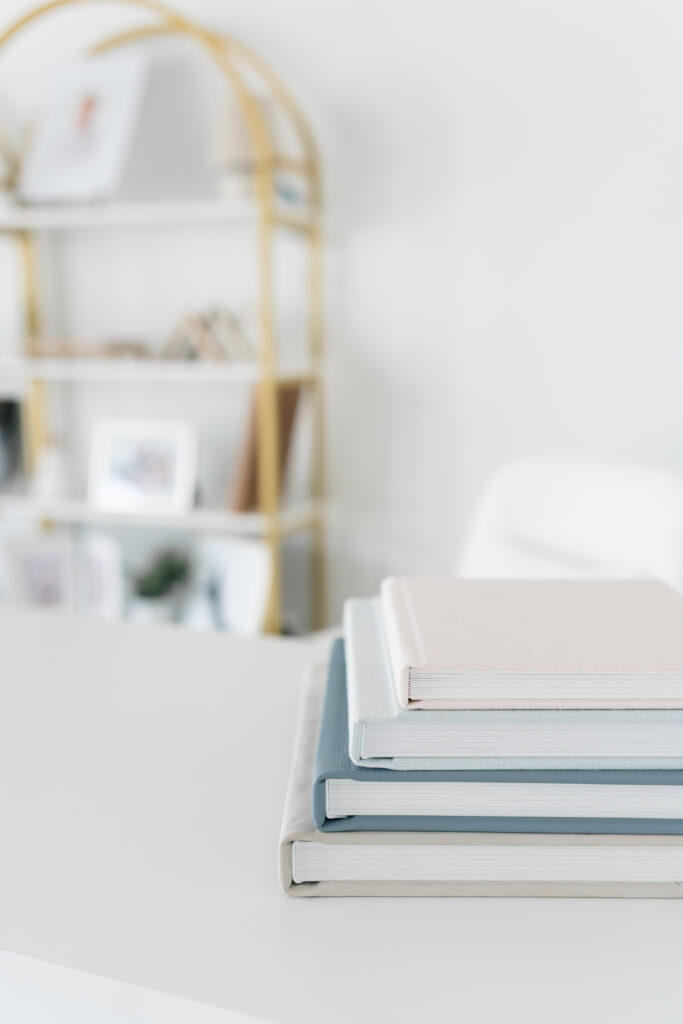 Stack of heirloom albums set on top of a table.