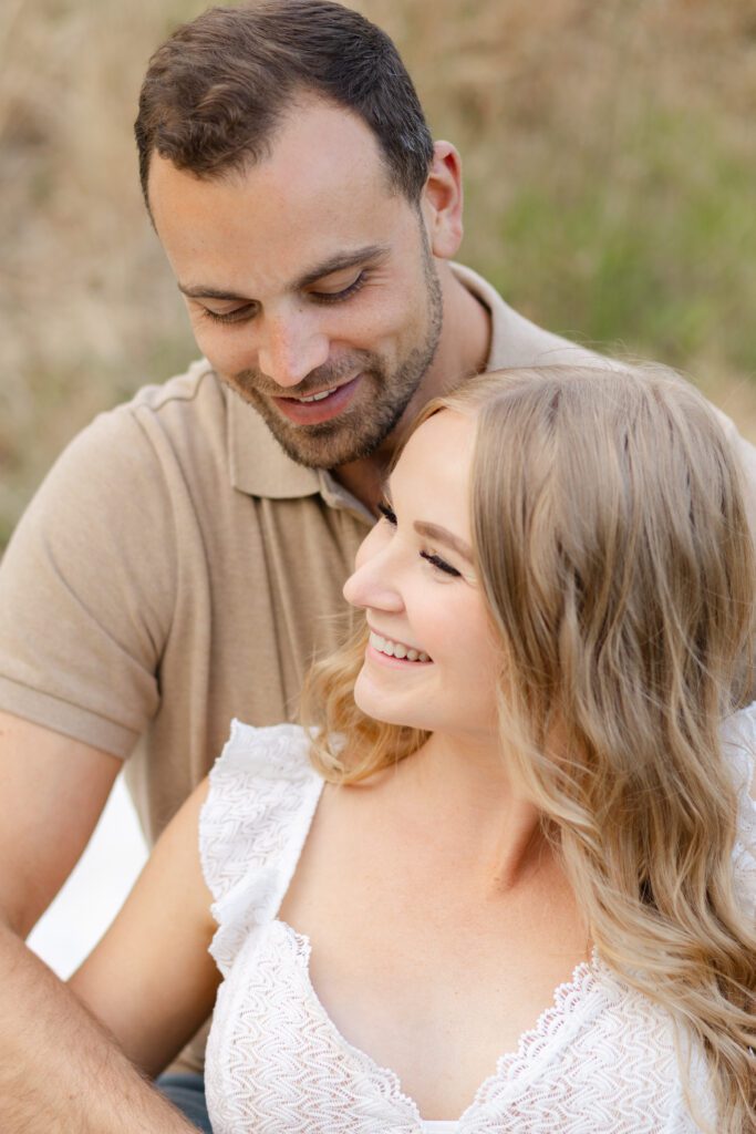 Couple laugh to themselves during their portrait session at Champoeg State Park.